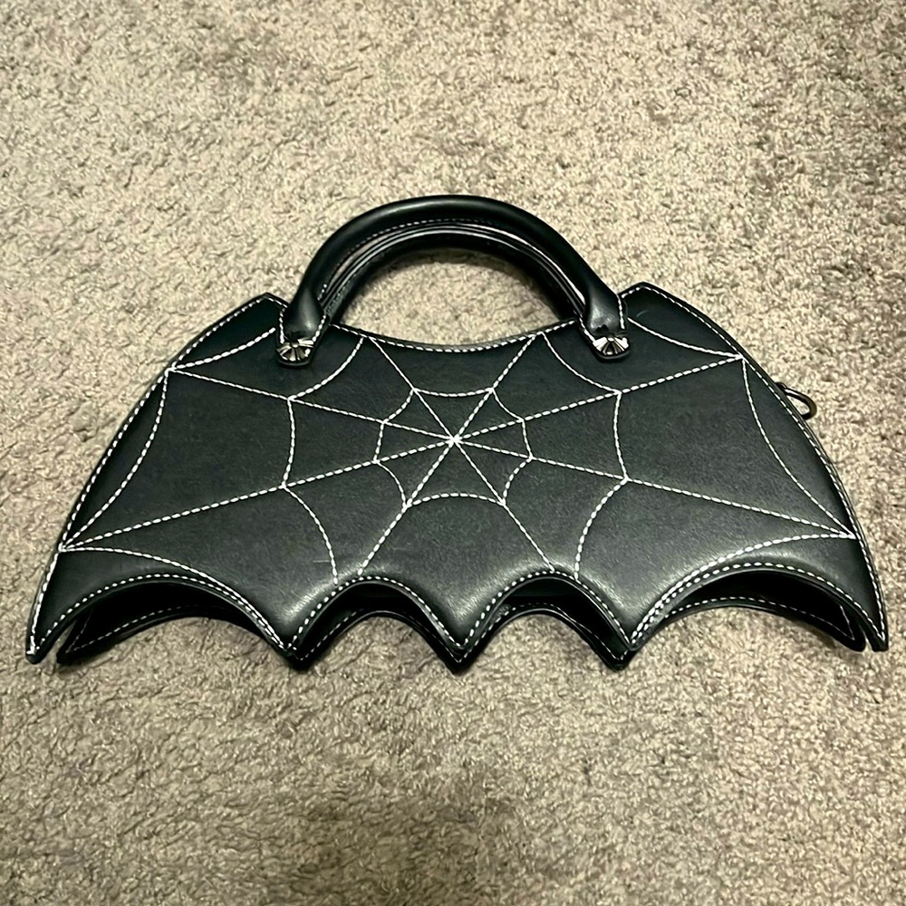 Bat shaped purse, black, hard shell, strap removable.